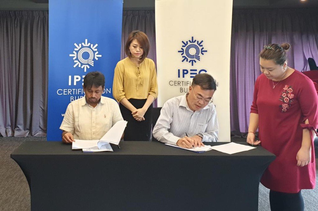 CFIPEC chief at the IPEC Certification Bureau table during the official signing of the Memorandum of Understanding.